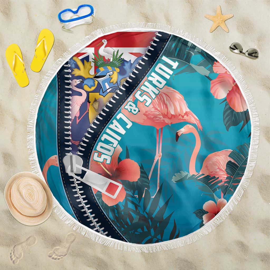 Round zippered beach blanket in turquoise with flamingo and tropical leaf print, fringe edge