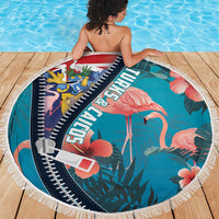Round zippered beach blanket in turquoise featuring flamingos, leaves, and white fringe edging
