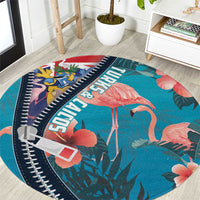 Turquoise round flamingo area rug with zipper-style navy border and tropical leaf print