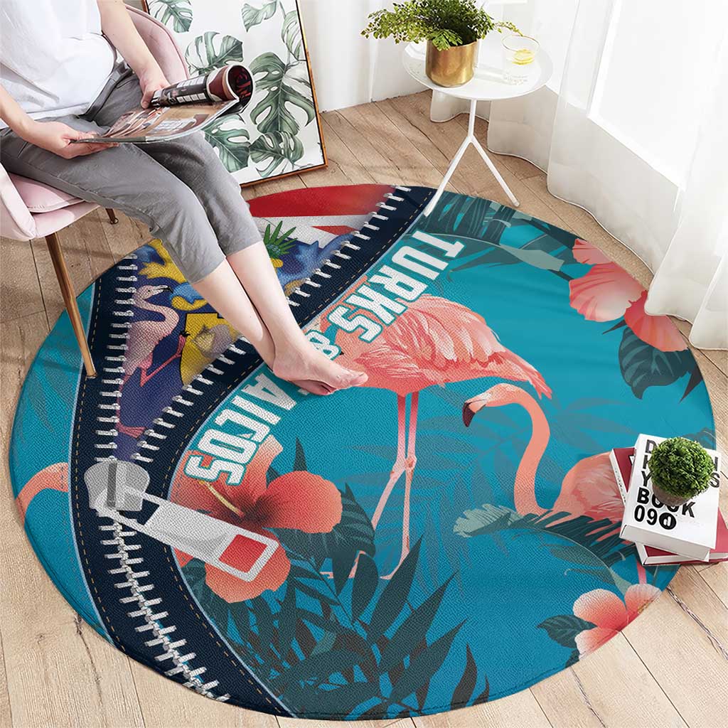 Turquoise round flamingo area rug with zipper-style navy edge and tropical leaf print