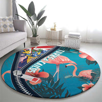 Turquoise round flamingo rug with zipper-style navy border, tropical florals and leaves