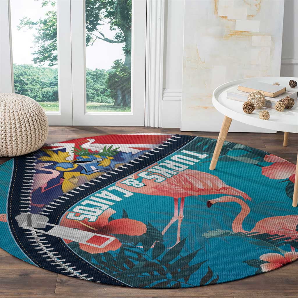 Turquoise round flamingo area rug with zipper-style navy trim and coral pink bird print