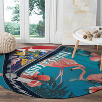 Turquoise round flamingo area rug with zipper-style navy trim and coral pink bird print