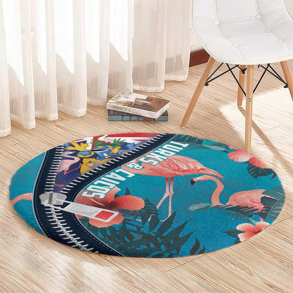 Turquoise round flamingo rug with zipper-style navy border and tropical leaf pattern