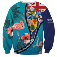 Unisex turquoise zipper sweatshirt with flamingos and Union Jack patches, ribbed cuffs.