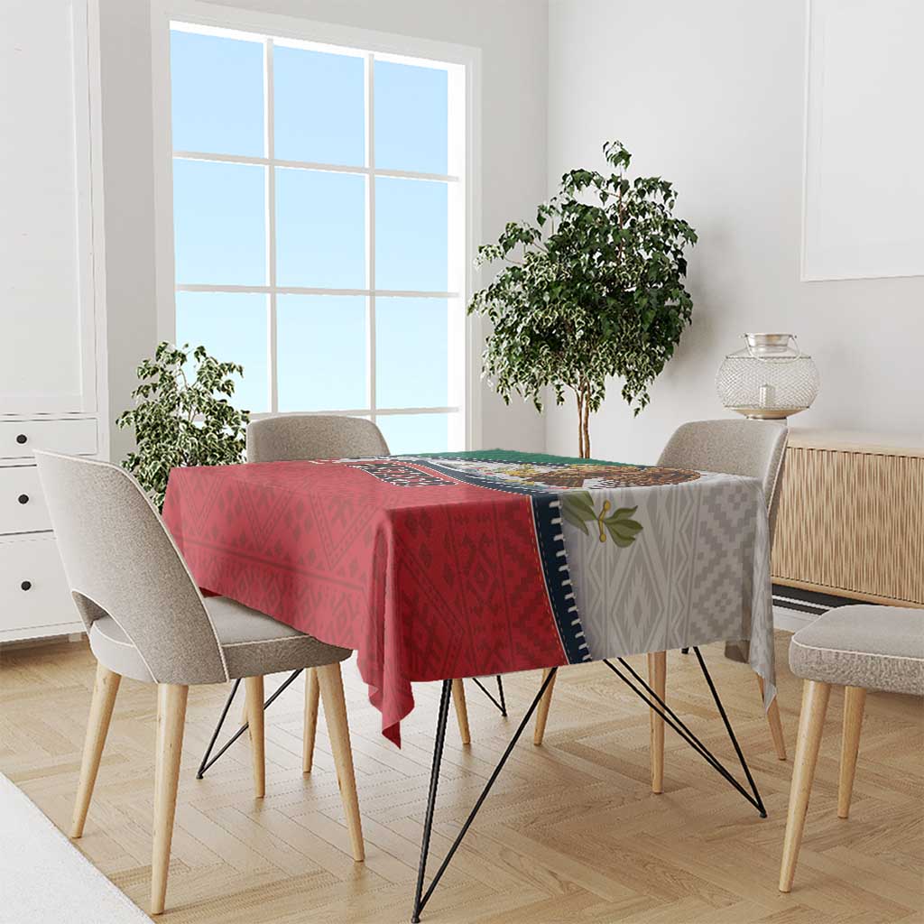 Mexico-themed tablecloth draped on dining table, red center with green edging and patterned trim