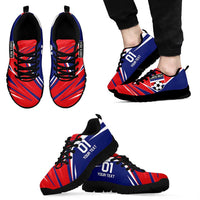 Red and blue soccer sneakers with black laces and black sole, side view