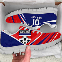 Blue and red soccer sneaker with white sole and white laces, tongue detail