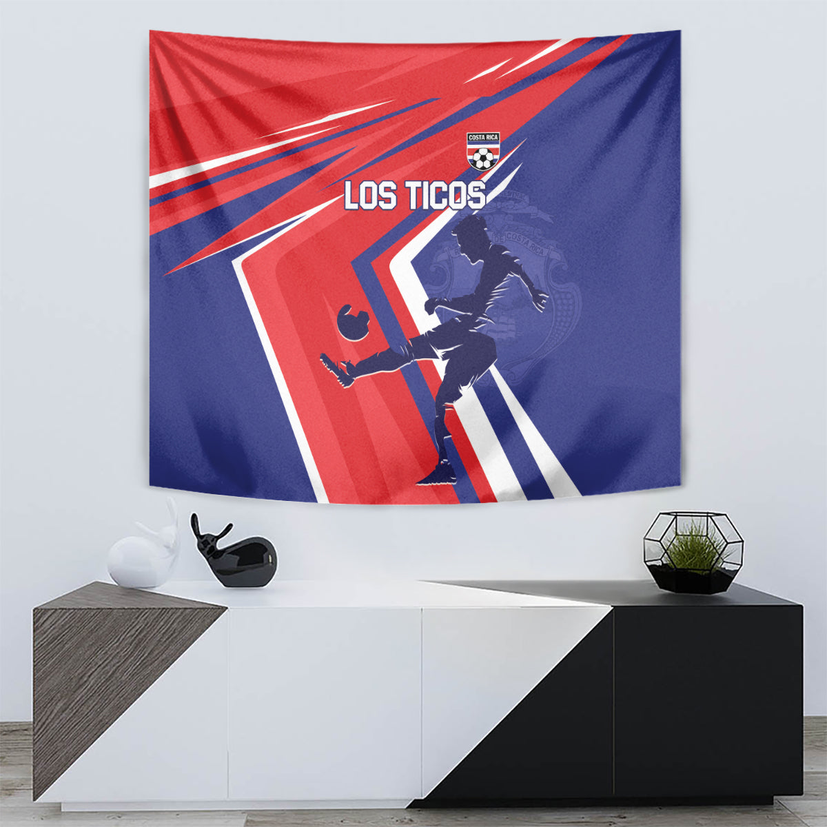 Costa Rica soccer tapestry hanging on wall, red and blue with 'LOS TICOS' player graphic