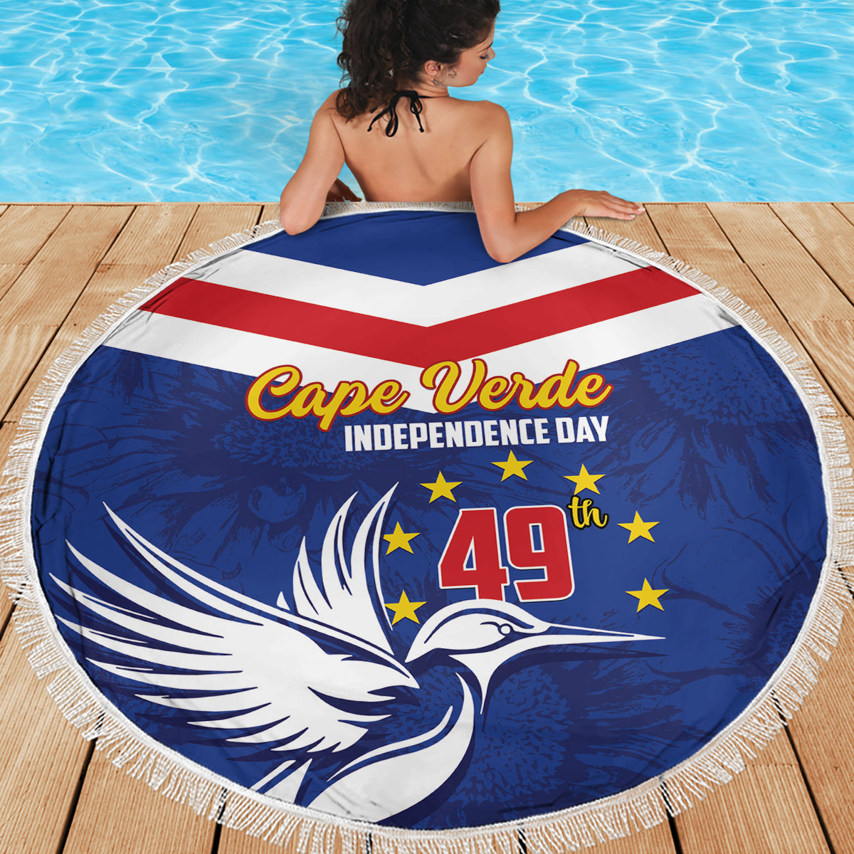 Blue round beach blanket with fringed edge and bird-and-star Independence Day design