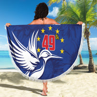 Blue round beach blanket with fringed edge, large graphic spread outdoors