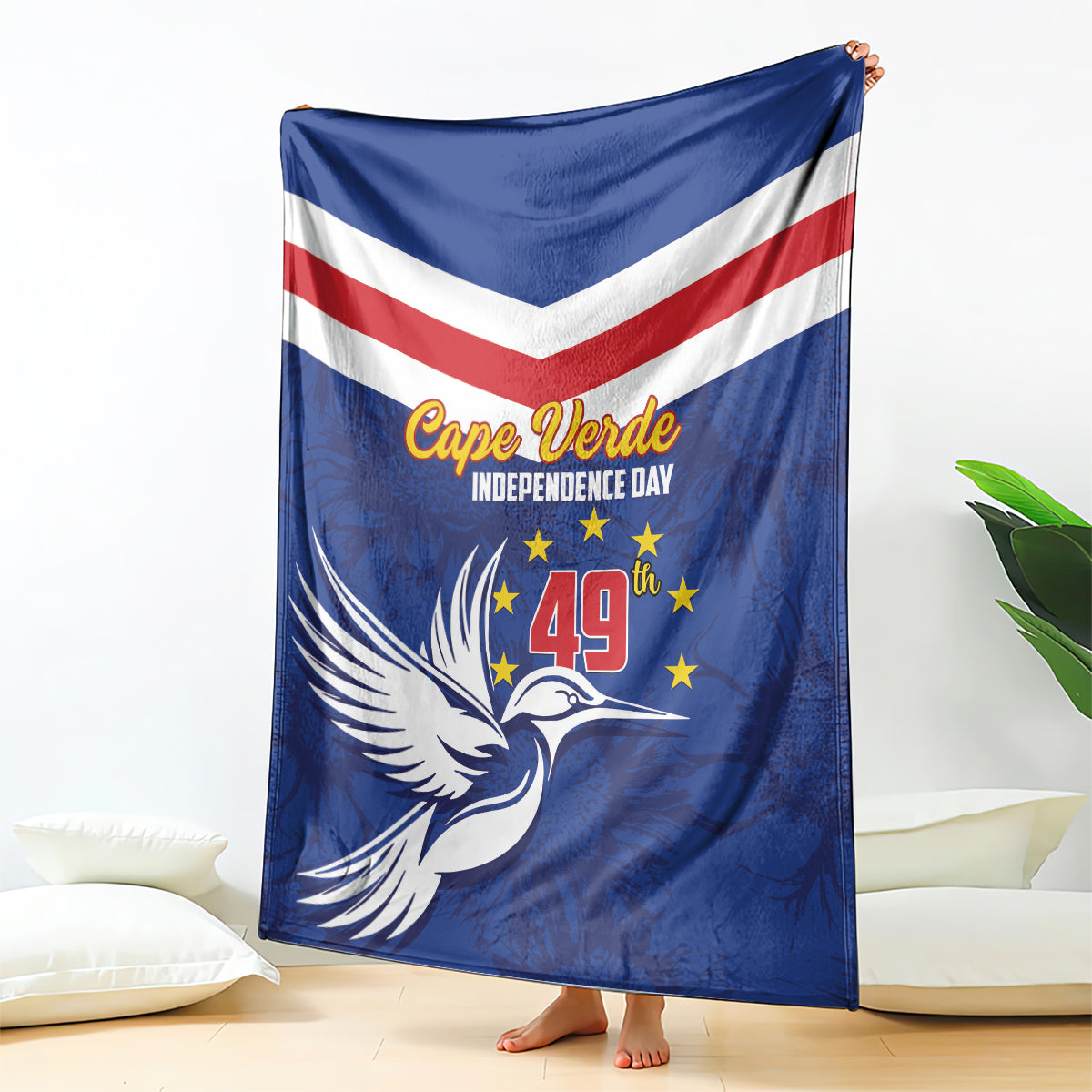 Blue independence day blanket with chevron stripes and dove graphic, draped on a stand