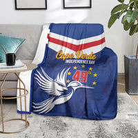 Blue independence day blanket with chevron stripes, dove and stars, folded over a sofa arm