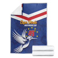 Blue independence day blanket with chevrons and dove graphic, folded with a white towel stack