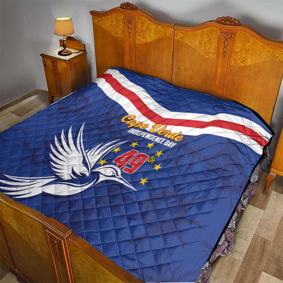 Blue Cape Verde Independence Day quilt on bed with flag stripe band and dove emblem
