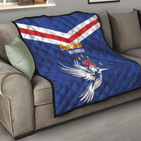 Blue Cape Verde Independence Day quilt draped on sofa with diagonal flag stripes and dove