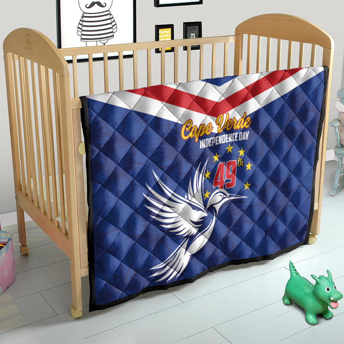 Blue Cape Verde Independence Day quilt on toddler bed with red-white stripe band and dove