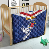 Blue Cape Verde Independence Day quilt on toddler bed with red-white stripe band and dove