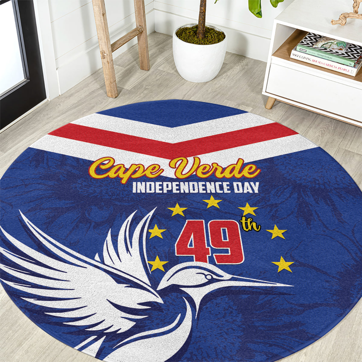 Blue round rug with bird and stars, Cape Verde Independence Day text, red-white stripe and 49