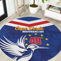 Blue round rug with bird and stars, Cape Verde Independence Day text, red-white stripe and 49