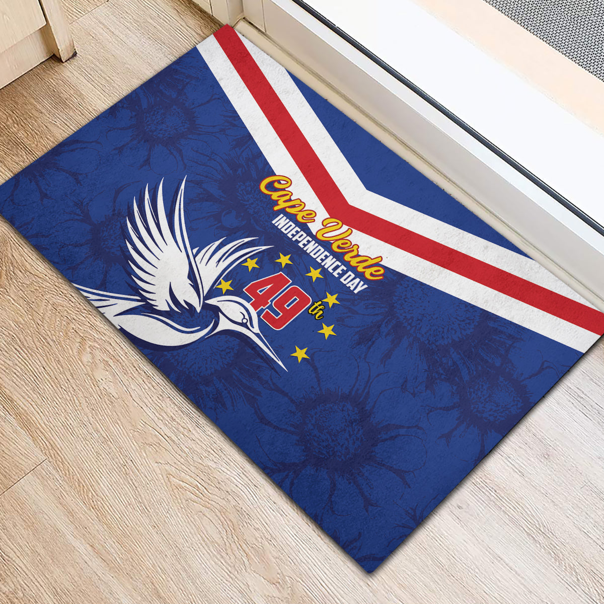 Blue rubber doormat angled view with red-and-white stripes and Cape Verde Independence Day text