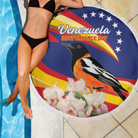 Round beach blanket draped over a person, showing Venezuela Independence Day toucan and flowers