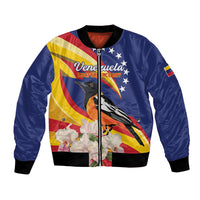 Blue bomber jacket with front zip, flag graphic, birds and white flowers, ribbed cuffs