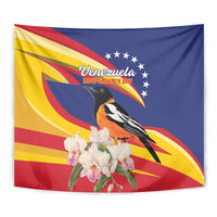 Venezuela flag tapestry showing a bird over red-yellow wave rays and white orchids