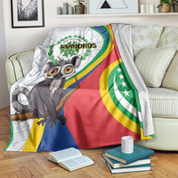 Comoros flag-themed blanket over sofa with lemur graphic, COMOROS emblem, and multicolor stripes.