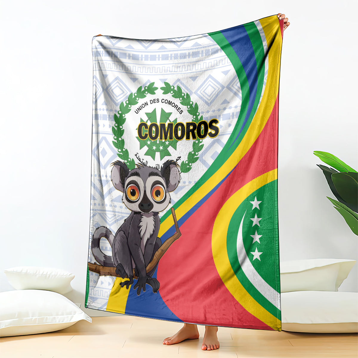 Comoros flag-themed blanket with lemur graphic, green laurel circle, and striped red/blue border.