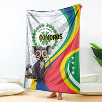 Comoros flag-themed blanket with lemur graphic, green laurel circle, and striped red/blue border.