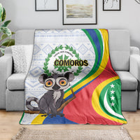 Comoros flag-themed blanket draped over couch, featuring lemur art and “COMOROS” emblem.