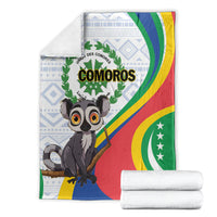 Comoros flag-themed blanket folded with lemur front art and COMOROS text in green laurel circle.