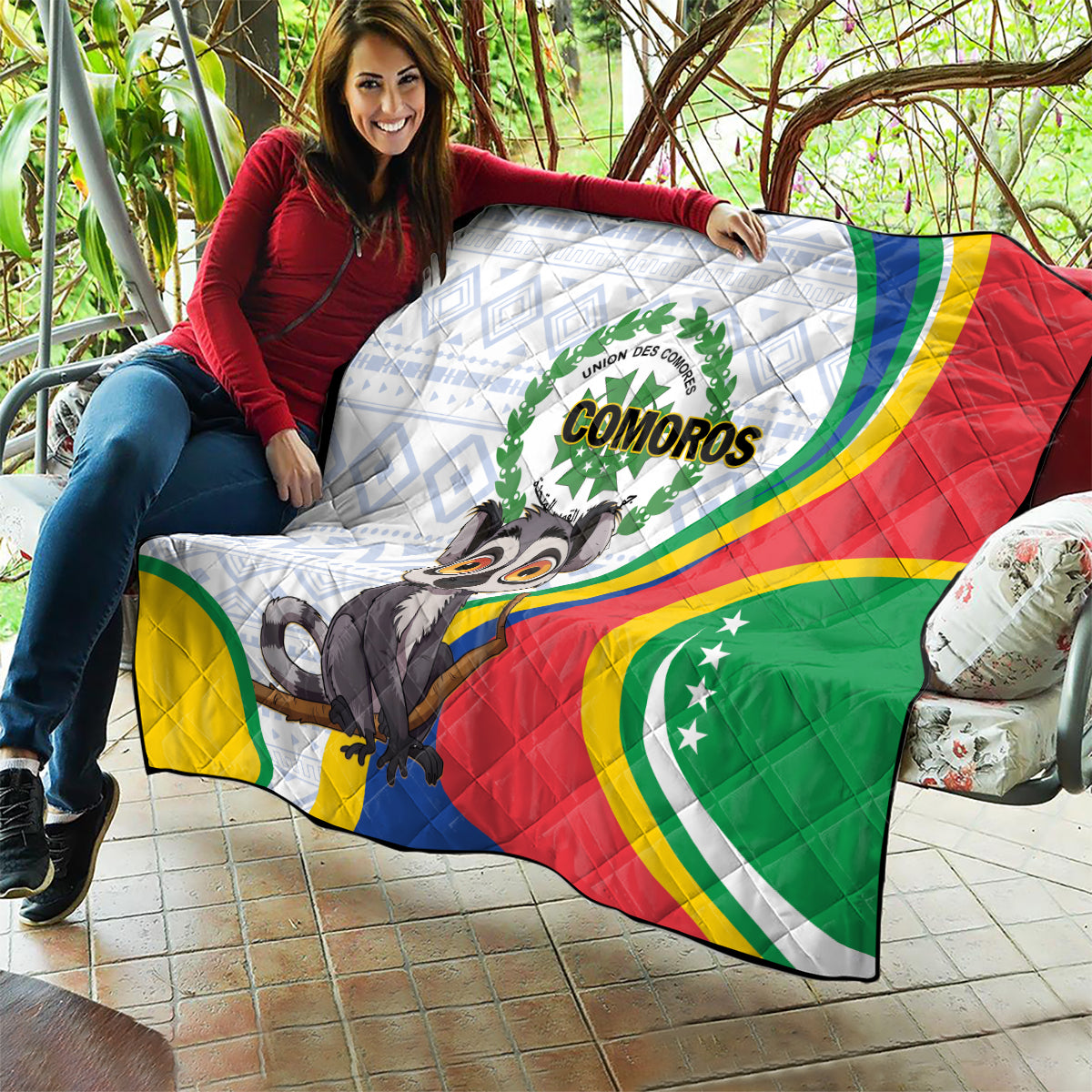 Comoros flag quilt stretched over a couch/seat, showing colorful stripes and lemur