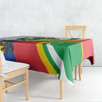 Flag-pattern tablecloth in red, green, yellow, and white with animal detail