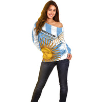 Off-shoulder striped sweater with ARGENTINA text and large yellow sun graphic