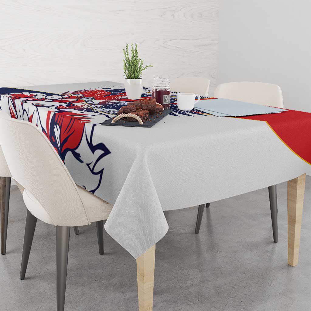 Red, blue, and white patterned tablecloth with eagle design over table surface.