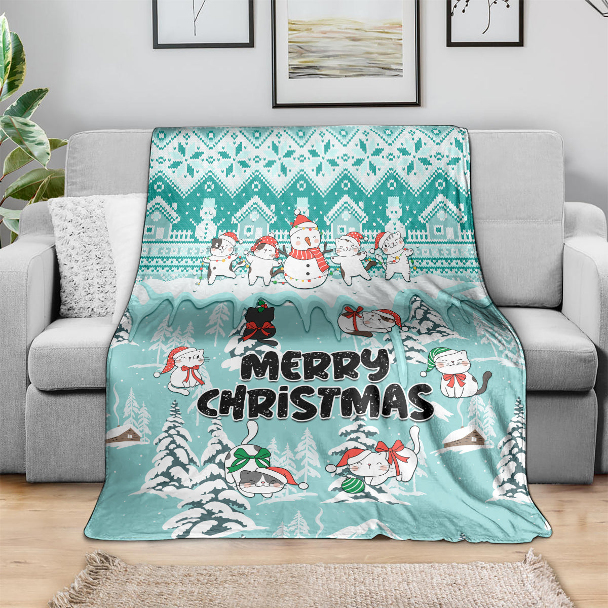 Turquoise Merry Christmas cat blanket draped over a sofa