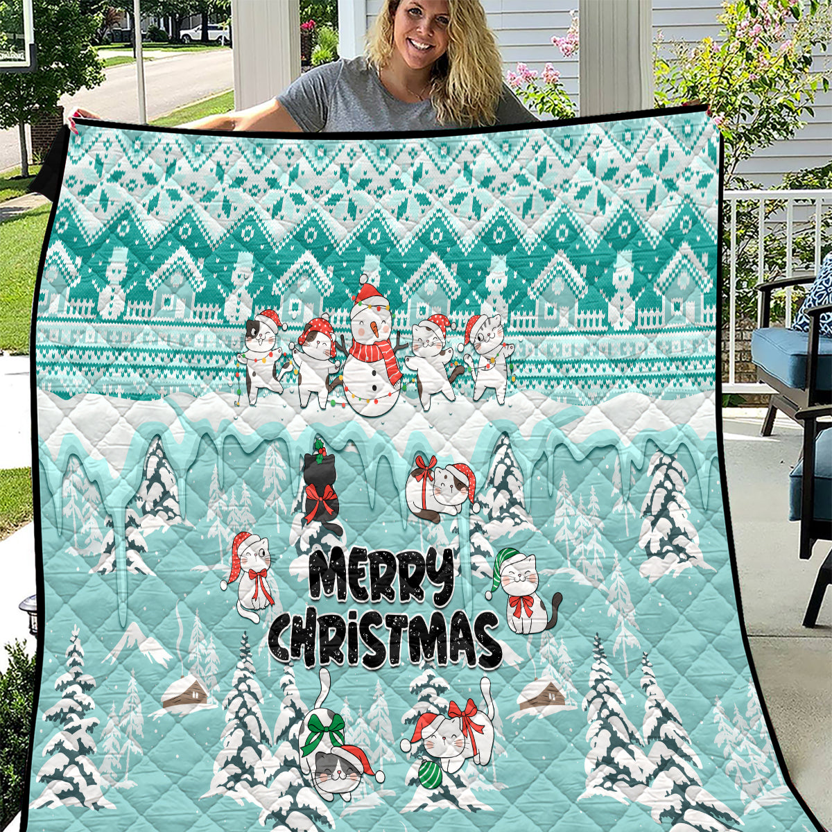 Turquoise Christmas quilt with cat characters, snowmen, and “Merry Christmas” text