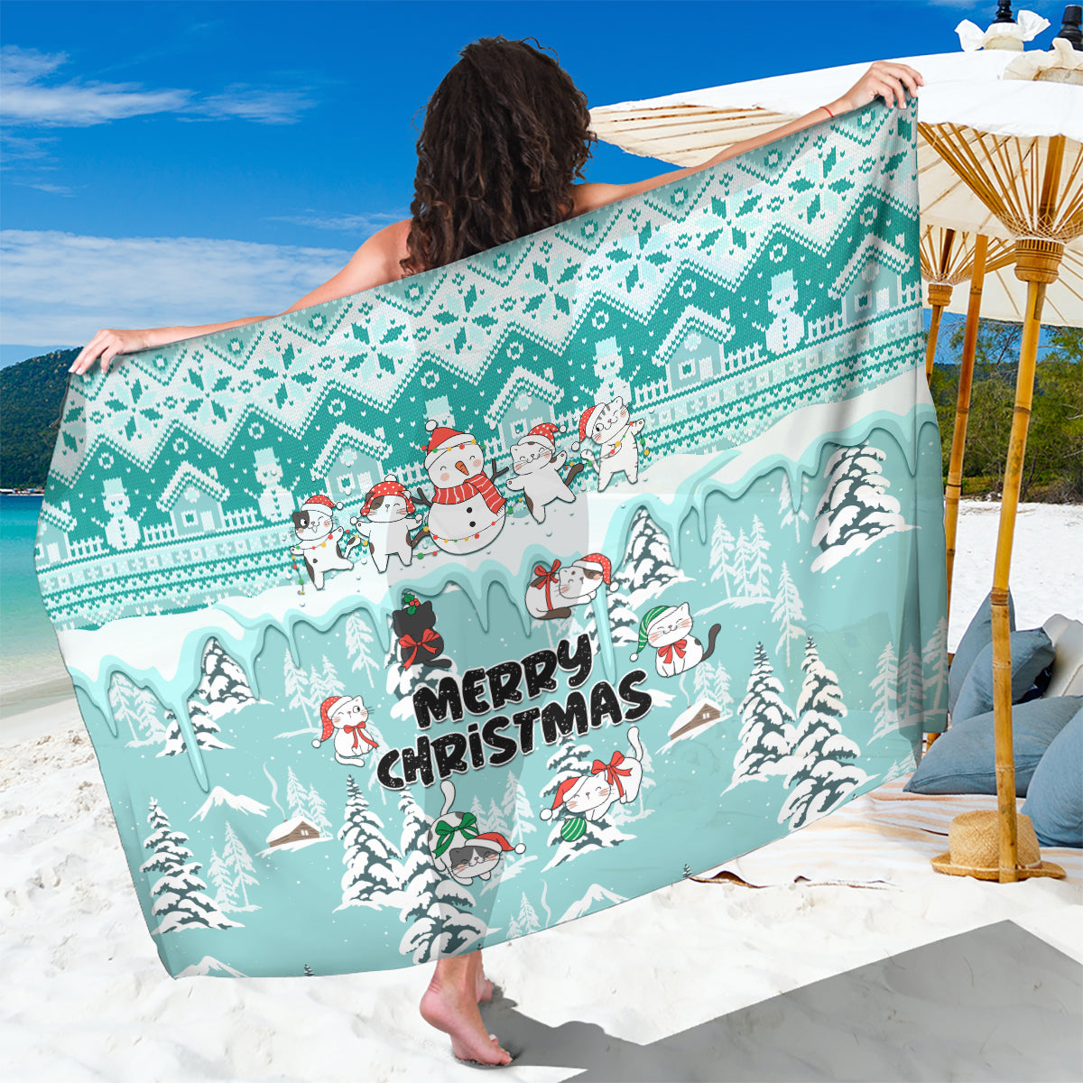 Turquoise Christmas sarong with cartoon cats, snowmen, and “Merry Christmas” text