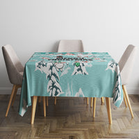 Turquoise winter tablecloth with mountain and cat silhouettes, set on round dining table