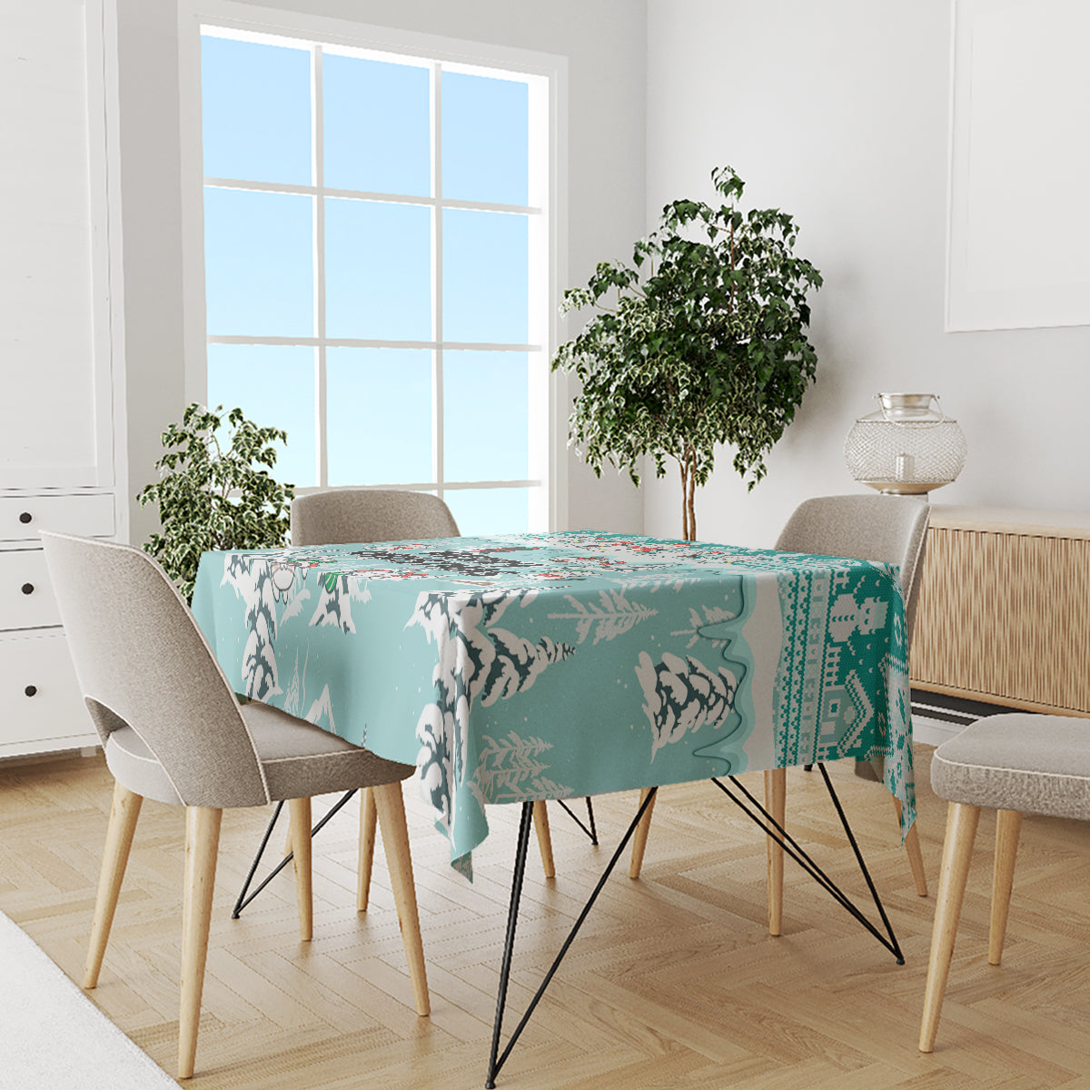 Turquoise tablecloth with cat silhouettes and Christmas border, on dining table with chairs