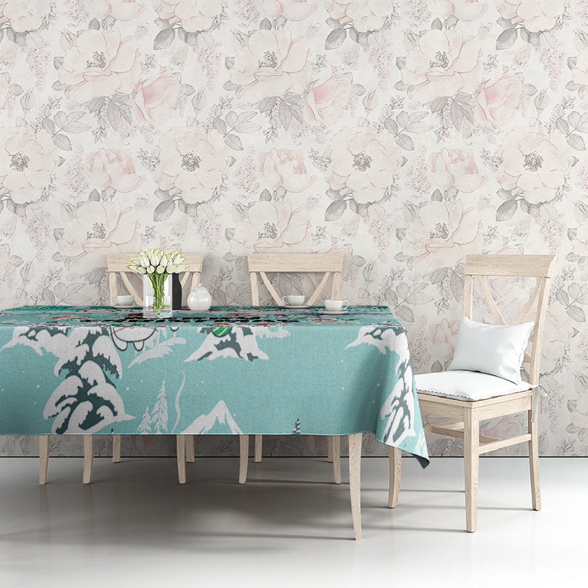 Turquoise tablecloth with cat silhouettes and winter mountains, laid across dining table