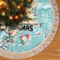 Turquoise cat tree skirt with snow-covered trees, cats, and fringed white trim