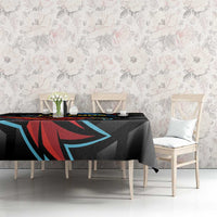 Black cricket tablecloth with Falcons artwork on dining table with chairs nearby