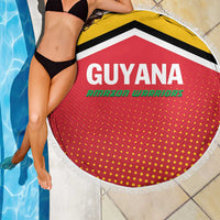 Red circular beach blanket with Guyana Amazon Warriors print, yellow stripe, white fringe trim