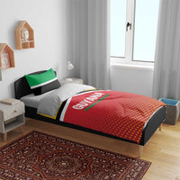 Guyana-themed duvet and pillow set on bed frame, red dotted duvet with green stripe