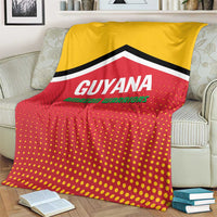Guyana cricket blanket spread on couch, yellow upper panel, red dotted lower panel, chevron trim.