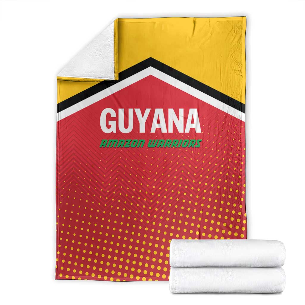 Guyana cricket blanket folded with yellow top and red dotted center, black/white chevron border.