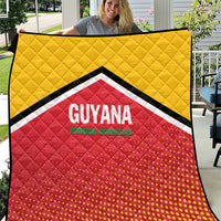 Yellow and red quilt with black-and-white chevron border and central GUYANA logo